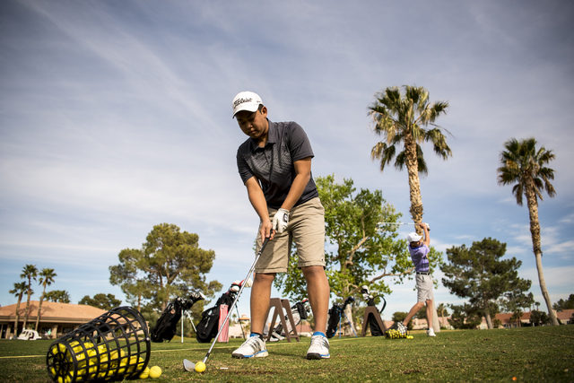 Desert Oasis golf team member Syouta Wakisaka prepares to swing during practice at Palm Vall ...