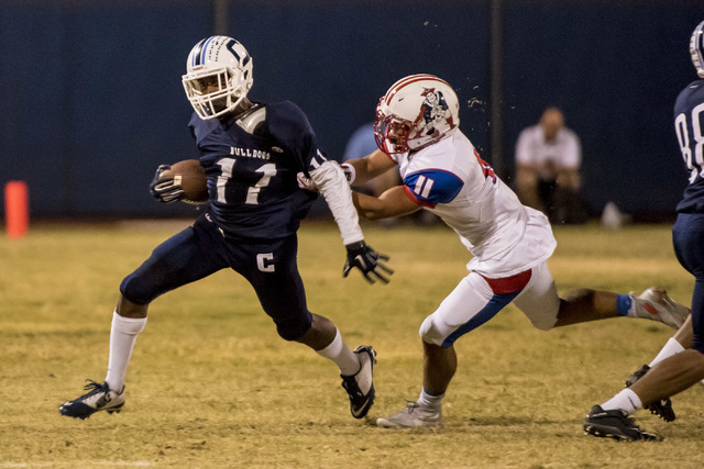 Liberty Patriots center back Jake Dedeaux (11) grabs Centennial Bulldogs receiver Savon Scar ...