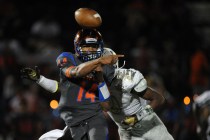 Bishop Gorman quarterback Dorian Thompson-Robinson (14) passes the ball while on being chase ...