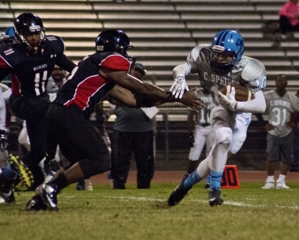 Canyon Springs‘ Diamante Burton (10) tries to elude tackers during their prep football ...