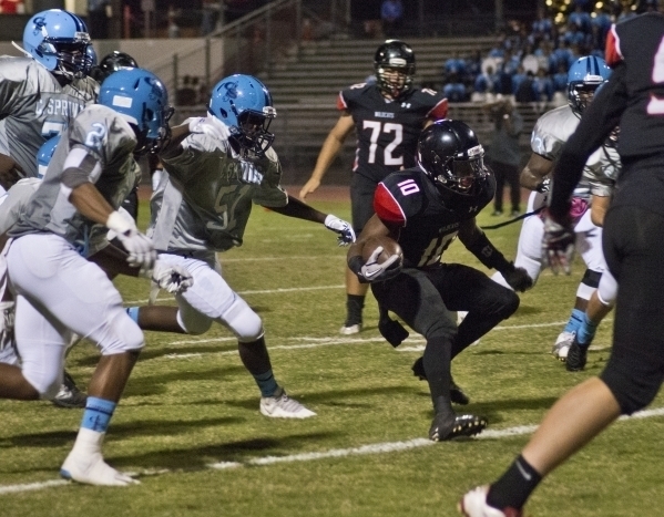 Las Vegas’ Elijah Hicks (10) runs the ball up the field during their prep football gam ...