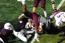 Don Bosco Prep Ironmen running back Malik Bakker is upended by Bishop Gorman linebacker Pala ...