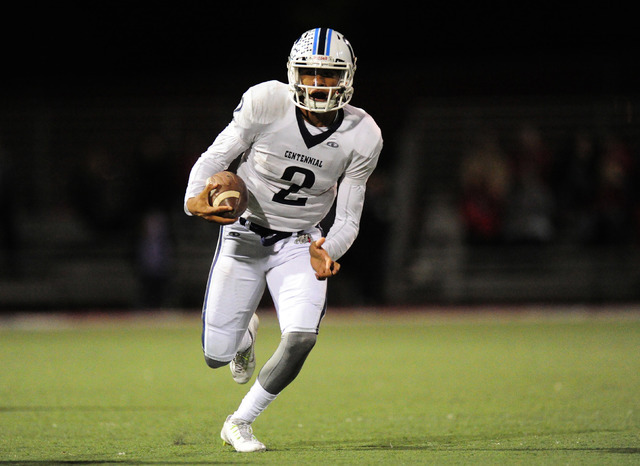 Centennial quarterback Jamaal Evans rushes against Arbor View in the first half of their pre ...