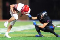 Bishop Gorman free safety Damuzhea Bolden (11) goes to tackle Arbor View fullback Andrew Wag ...