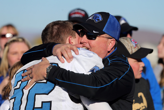 Pahranagat Valley Head Coach Ken Higbee and his son Christian celebrate after defeating Whit ...