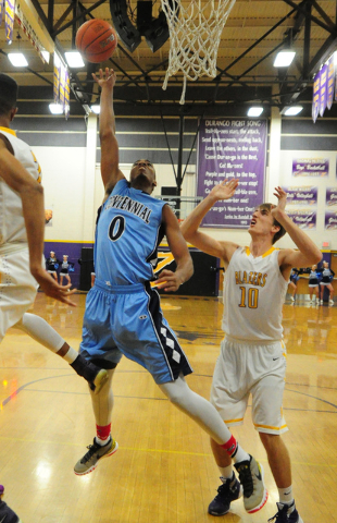 Centennial guard Troy Brown (0) goes up for a shot in front of Durango forward Jason Landman ...