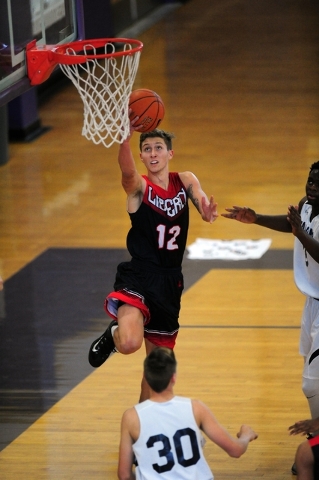 Liberty guard Kyle Thaxton scores on a layup attempt against Coral Academy in the first half ...
