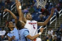 Bishop Gorman’s Chase Jeter shoots over Canyon Springs defenders Darrell McCall and Jo ...
