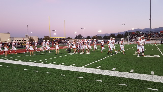 Liberty’s football team enters the field for its game Friday against Centennial-Corona ...