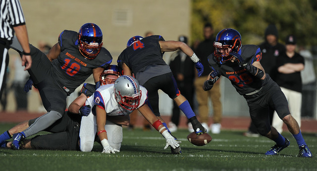 Liberty running back Spencer Wilson (8) fumbles the ball while being wrapped up by a host of ...