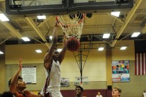 Desert Oasis forward Aamondae Coleman (5) dunks in front of Legacy forward Frank Robinson in ...