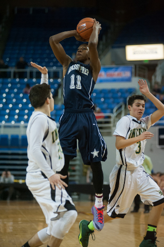 Agassi’s Deishuan Booker (11) shoots a jump shot against Incline’s Alex Zissis ( ...