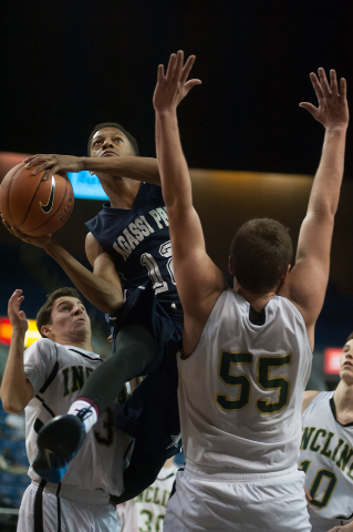 Agassi Prep’s Kobe Williams (12) tries to shoot around Incline’s Ben Snyder (55) ...