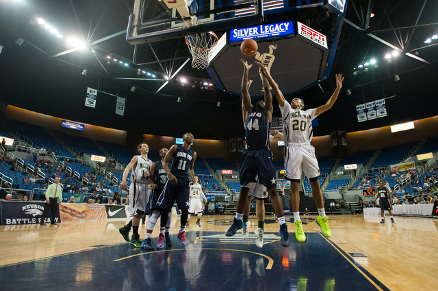 Agassi Prep’s Dennis Walker (44) goes against Incline’s Orin Porter (20) for a r ...