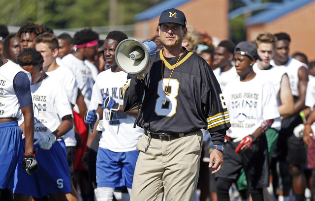 Michigan football coach Jim Harbaugh urges the more than 500 high school football players to ...
