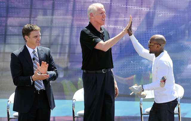 Boxer Floyd Mayweather Jr., right, greets Bill Walton with a high-five as Luke Robitaille, p ...