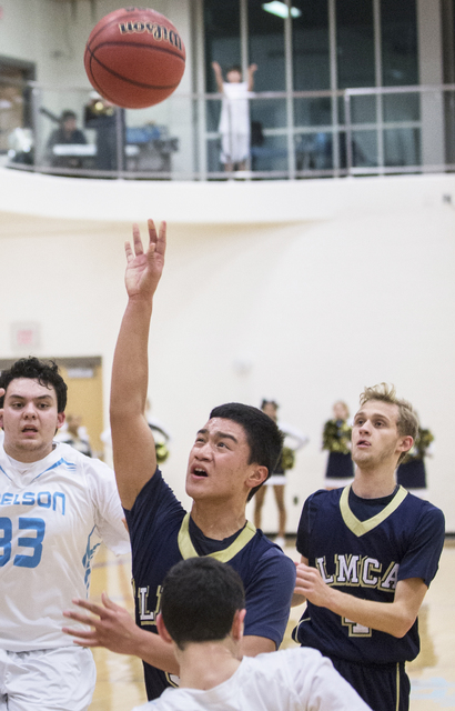 Lake Mead’s Kai Madela (5) drives past Adelson School’s Liddor Bega (23) and Bra ...