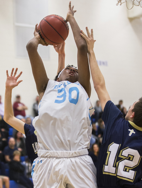 Adelson School’s Miles Hagan (30) drives to the basket over Lake Mead’s Sean Ful ...