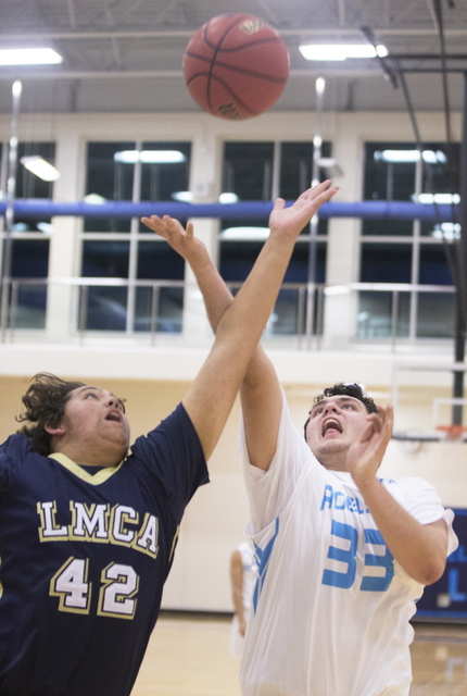 Adelson School’s Brandon Pappas (33) fights for a rebound with Lake Mead’s Nick ...