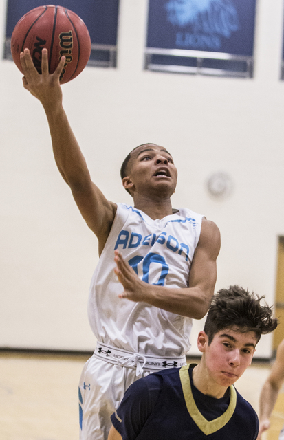 Adelson School’s Jalen Pitts (10) converts a fast break layup over Lake Mead’s S ...