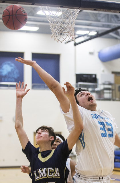 Adelson School’s Brandon Pappas (33) fights for a rebound with Lake Mead’s Shay ...