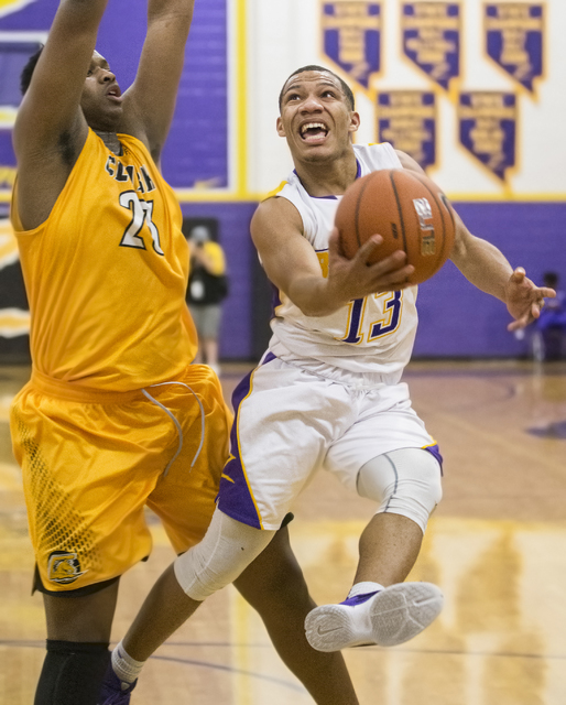 Durango’s Demetrius Valdez (13) drives to the basket past Clark’s Antwon Jackson ...