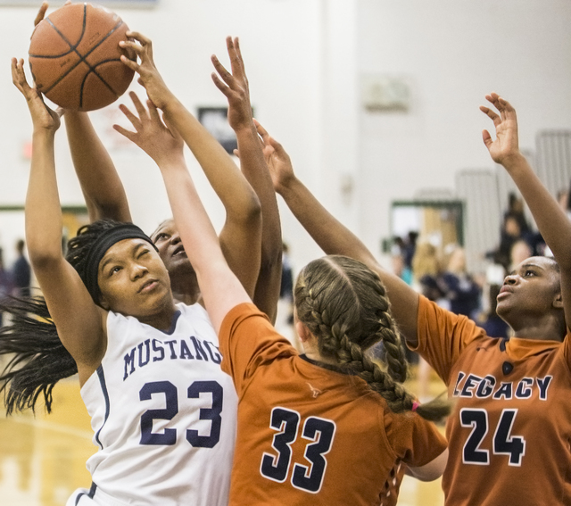Shadow Ridge’s Isis Triplett (23) fights for a rebound with Legacy’s Samantha Gr ...