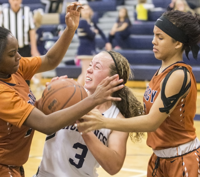 Shadow Ridge’s Caitlyn Covington (3) gets fouled on the way to the basket by Legacy&#8 ...