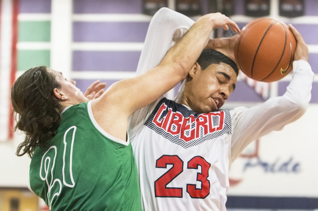 Liberty’s Julian Strawther (23) gets fouled by Green Valley’s Canyon Lewis (21) ...
