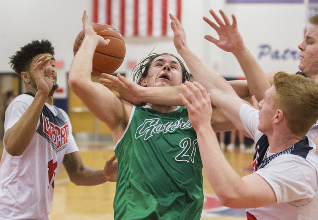 Green Valley’s Canyon Lewis (21) fights for a rebound with Liberty’s Braden Cain ...