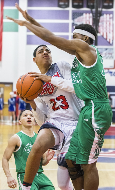 Liberty’s Julian Strawther (23) collides with Green Valley’s Deontae Tillman (22 ...