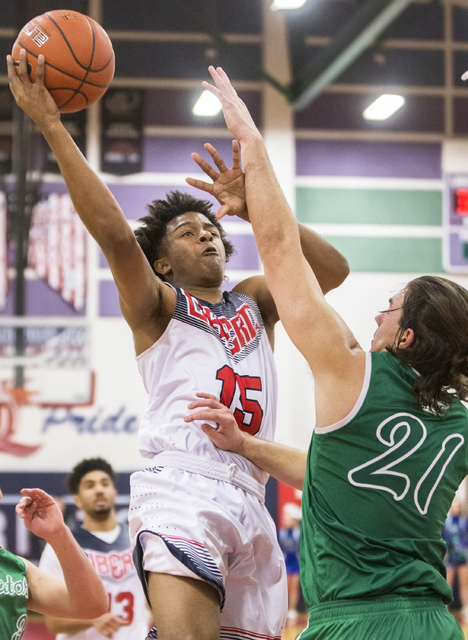 Liberty’s Cameron Burist (15) drives to the basket over Green Valley’s Canyon Le ...