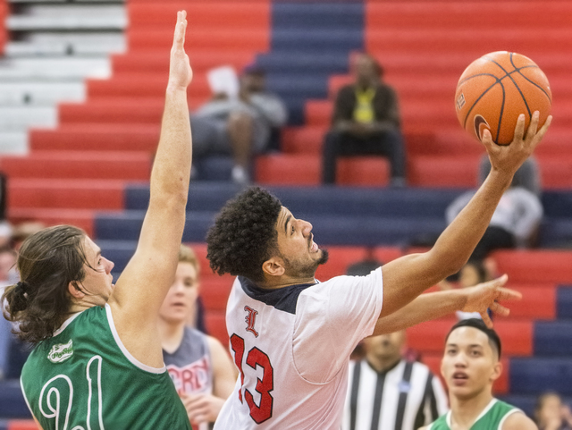 Liberty’s Dyllan Robinson (13) slices to the basket past Green Valley’s Canyon L ...