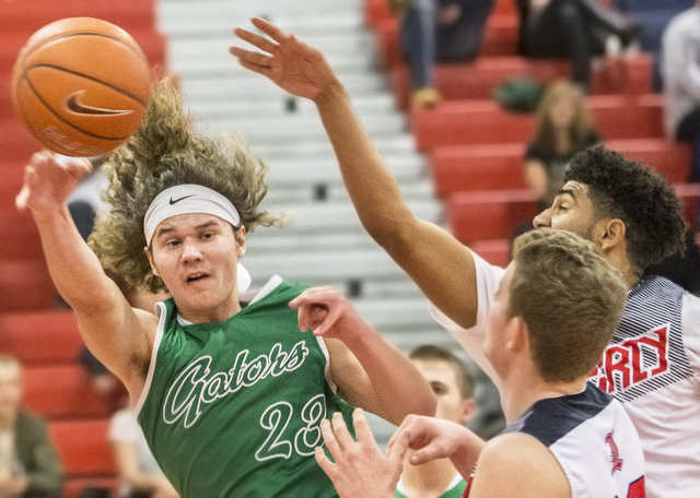 Green Valley’s Matthew Tuttle (23) makes a wrap around pass past Liberty’s Dylla ...