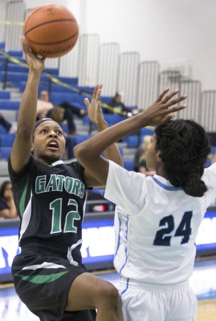 Green Valley’s Jamaica Lewis (12) drives past Canyon Springs’ Dayonna Maddox (24 ...