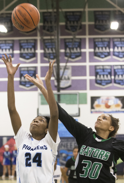 Green Valley’s (30) fights for a rebound with Canyon Springs’ Dayonna Maddox (24 ...
