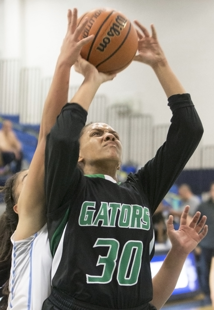 Green Valley’s Samara Miller (30) drives past a Canyon Springs defender during the Sun ...