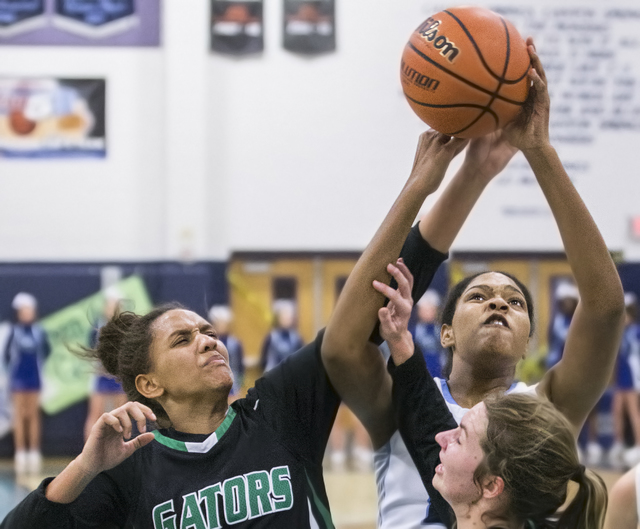 Canyon Springs’ Yemiyah Morris (20) fights for a loose ball with Green Valley’s ...