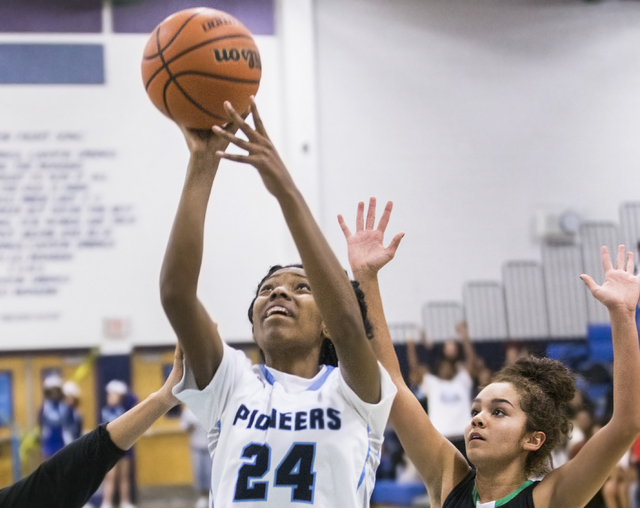 Canyon Springs’ Dayonna Maddox (24) drives to the basket past Green Valley’s Amy ...