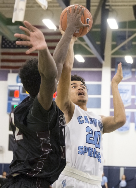 Canyon Springs’ Joseph Haulcy (20) shoots over Cimarron-Memorial’s Brian Washing ...