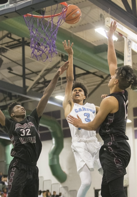 Canyon Springs’ Michael Washington (3) slashes past Cimarron-Memorial’s Brian Wa ...