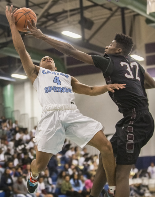 Canyon Springs’ Kevin Legardy (4) shoots a contested layup over Cimarron-Memorial&#821 ...