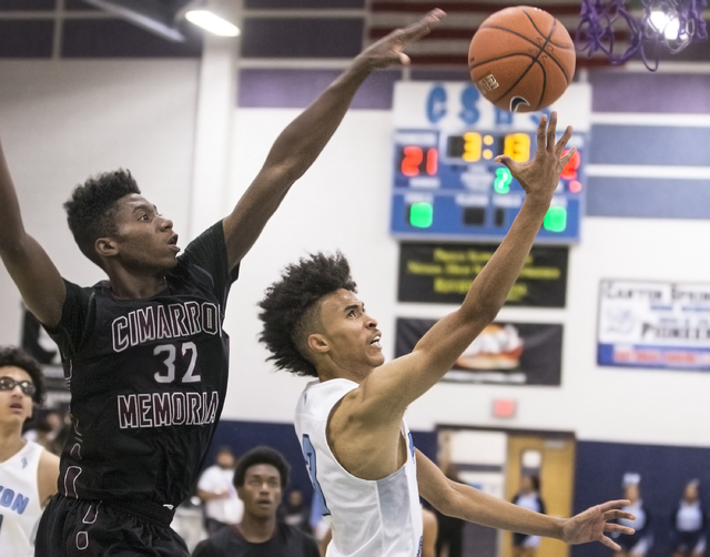 Canyon Springs’ Michael Washington (3) drives past Cimarron-Memorial’s Brian Was ...