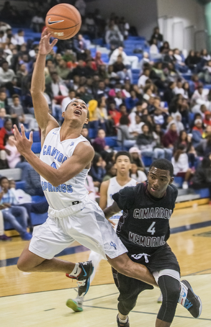 Canyon Springs’ Kevin Legardy (4) slashes to the rim past Cimarron-Memorial’s De ...