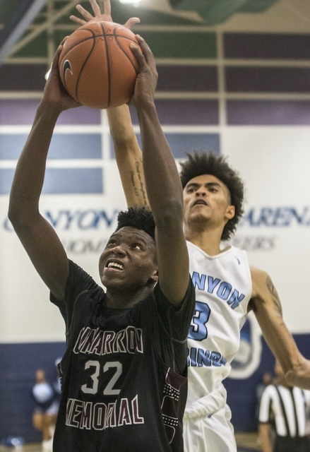 Cimarron-Memorial’s Brian Washington (32) drives past Canyon Springs’ Michael Wa ...