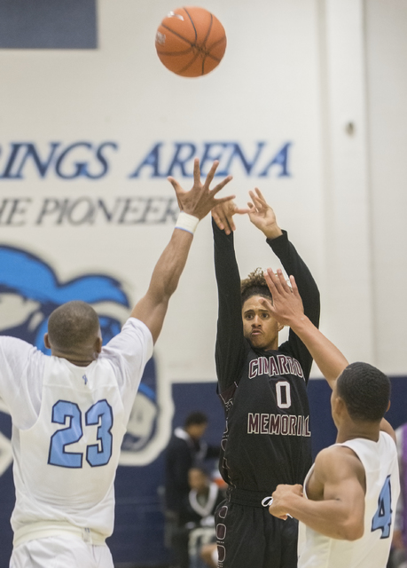 Cimarron-Memorial’s Keiron Hatchett (0) shoots over Canyon Springs’ Elbert Bibbs ...