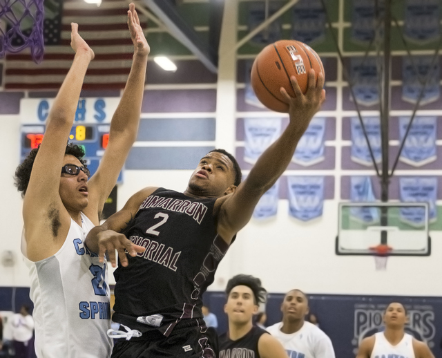 Cimarron-Memorial’s Elijah Coleman (2) drives past Canyon Springs’ Dareon House ...