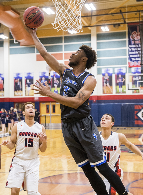 Desert Pines’ Trevon Abdullah-Booker (3) drives baseline past Coronado defenders on Mo ...