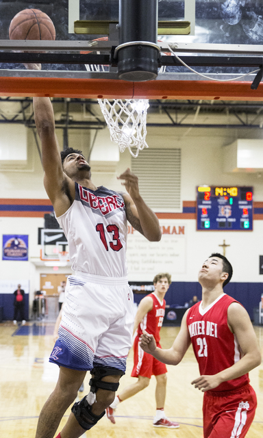 Liberty’s Dyllan Robinson (13) drives past Mater Dei’s Michael Wang (23) during ...