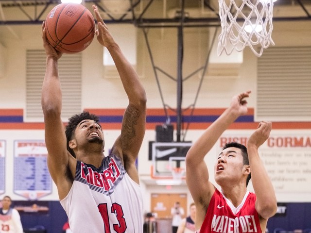 Liberty’s Dyllan Robinson (13) shoots over Mater Dei’s Michael Wang (23) during ...